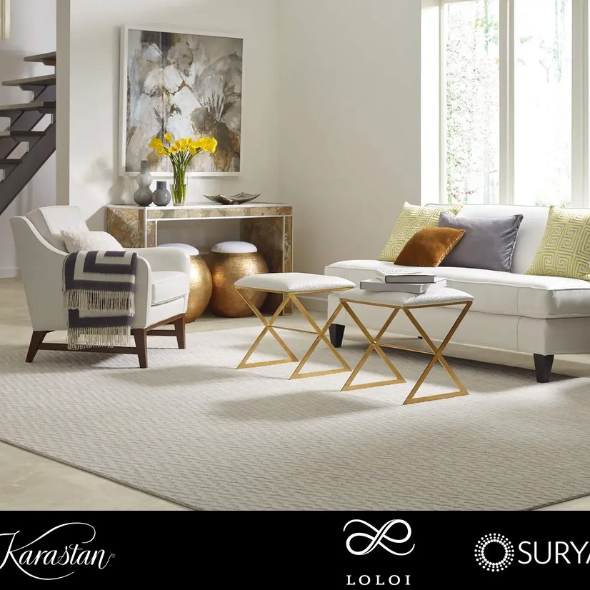 Area rug layered over hard-surface flooring in a short-term rental living room